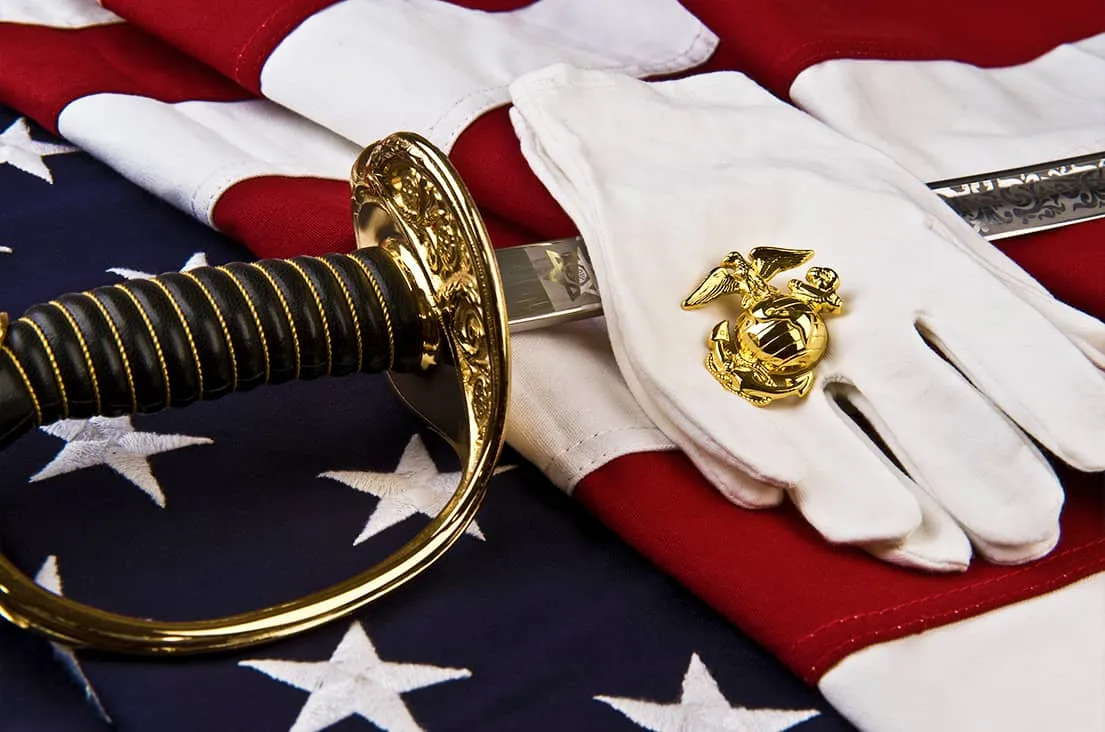 Marine ceremonial sword and Eagle, Globe and Anchor on an American flag